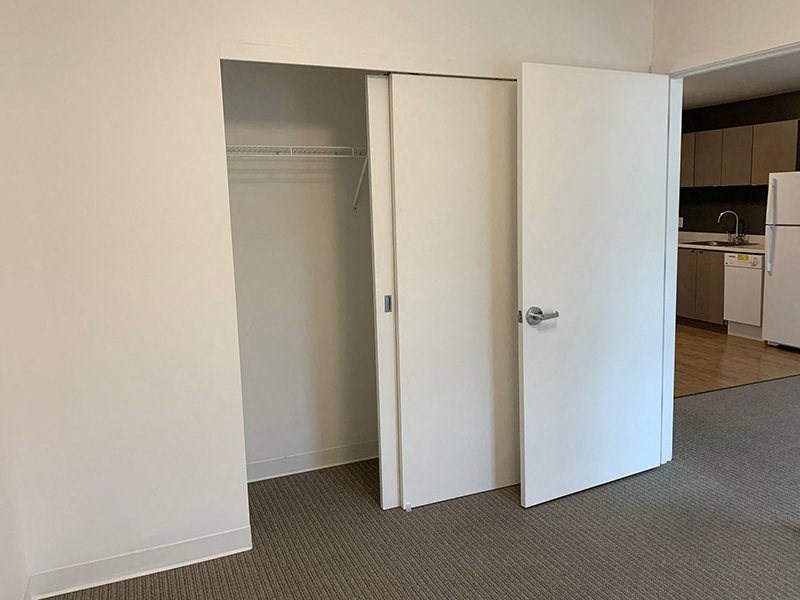 an empty room with an open closet door