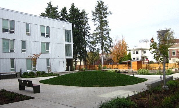 a courtyard in front of a white building