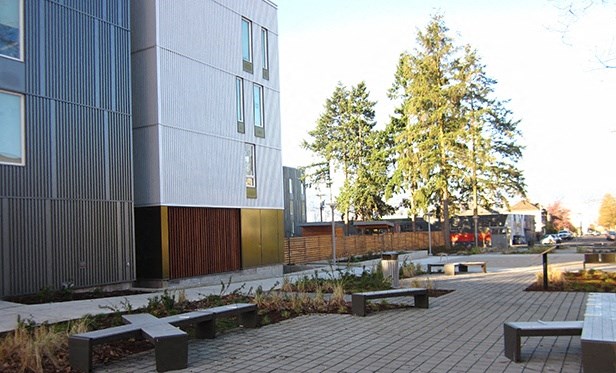 a courtyard with benches in front of a building