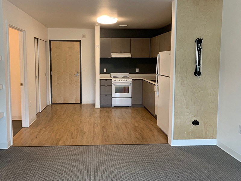 an empty kitchen with a stove and a refrigerator