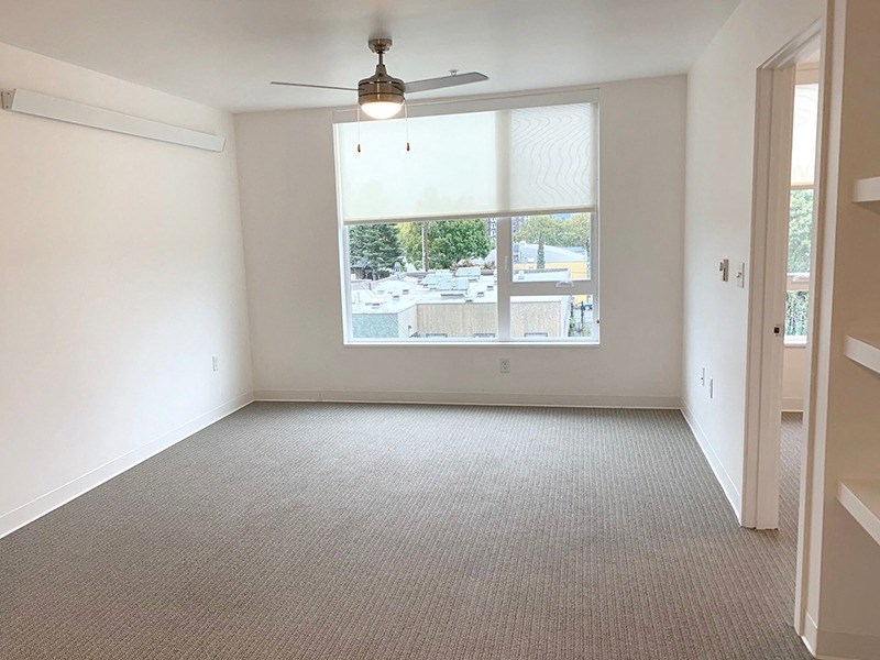 an empty living room with a large window