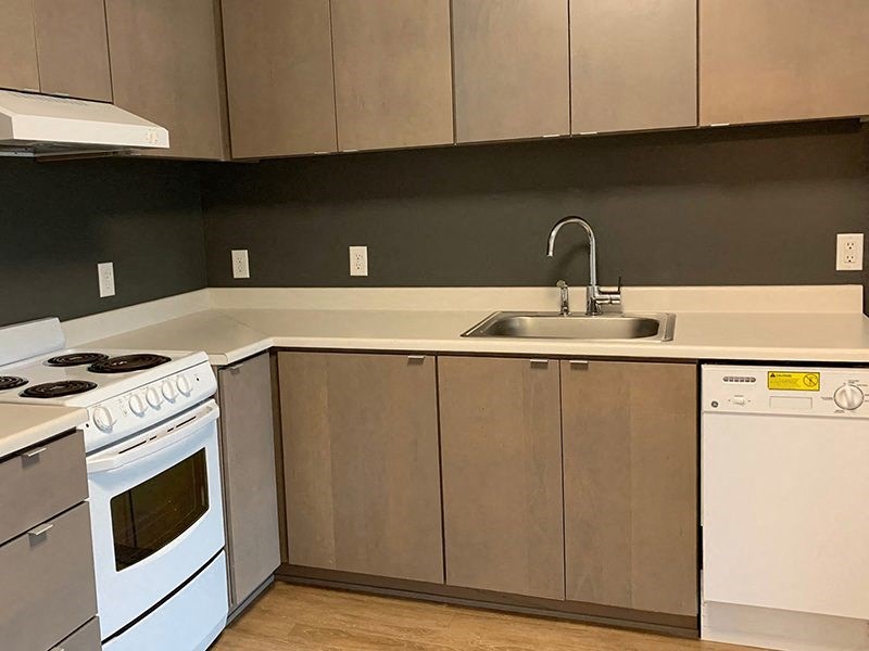 a kitchen with a white stove and a sink