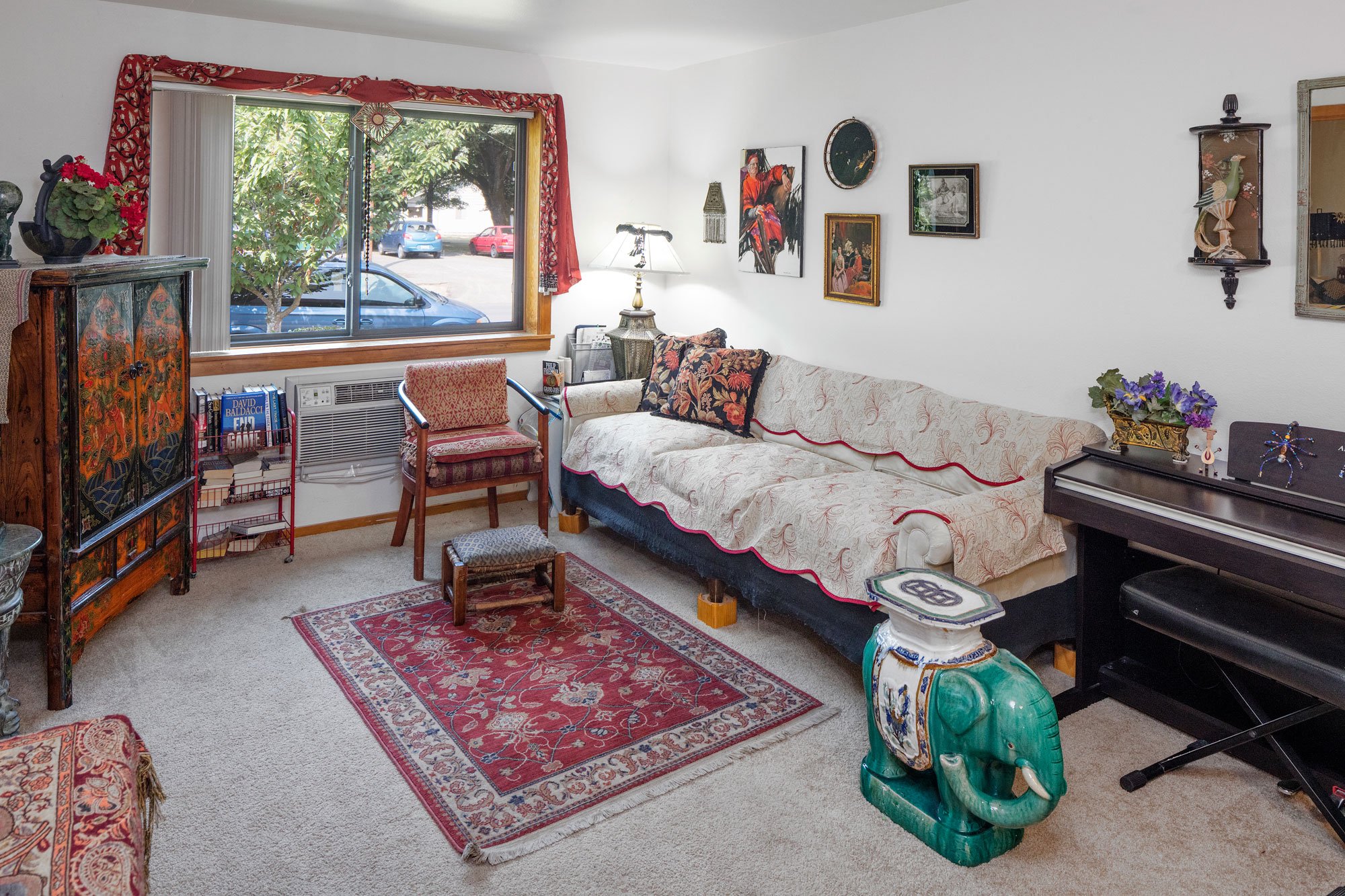 a living room filled with furniture and a piano