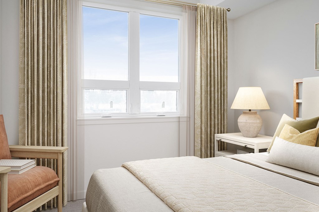 a bedroom with a large bed and a large window