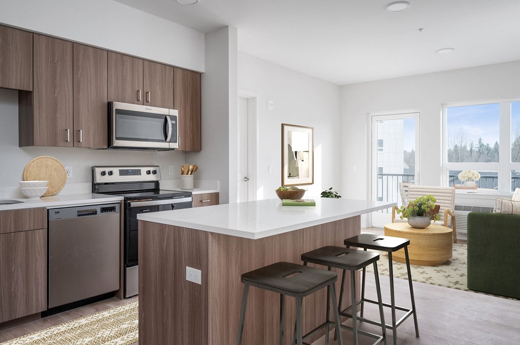a kitchen with an island and stools in a 555 waverly unit