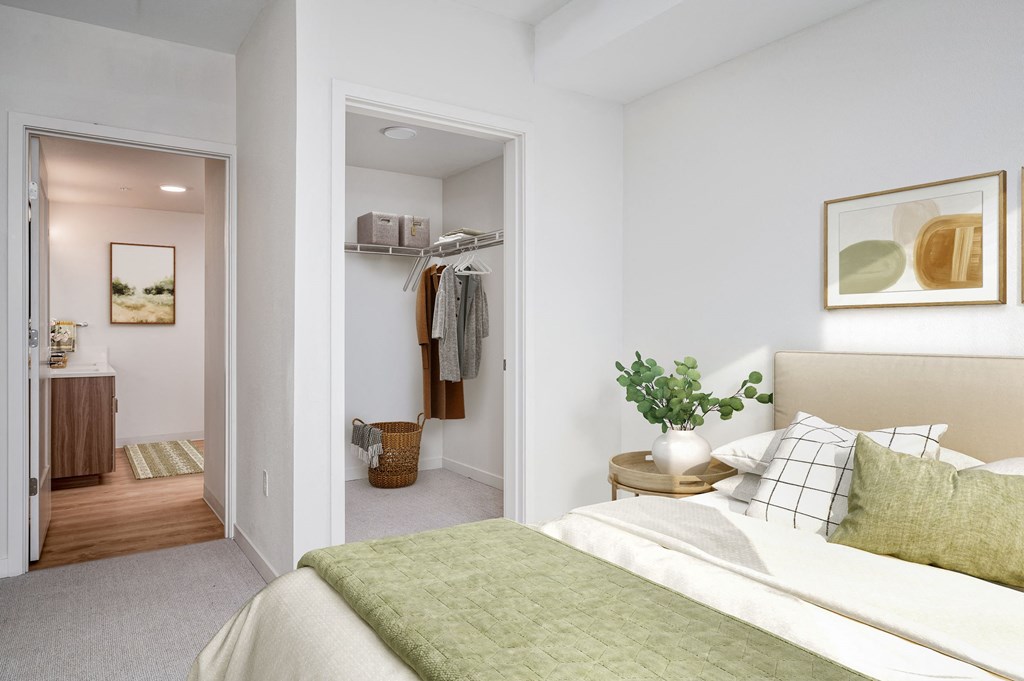a bedroom with white walls and a green bedspread