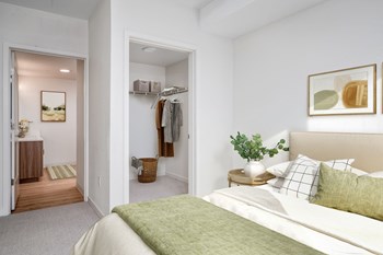 a bedroom with white walls and a green bedspread - Photo Gallery 24