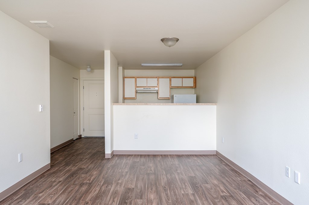 A room with wooden floors and white walls.