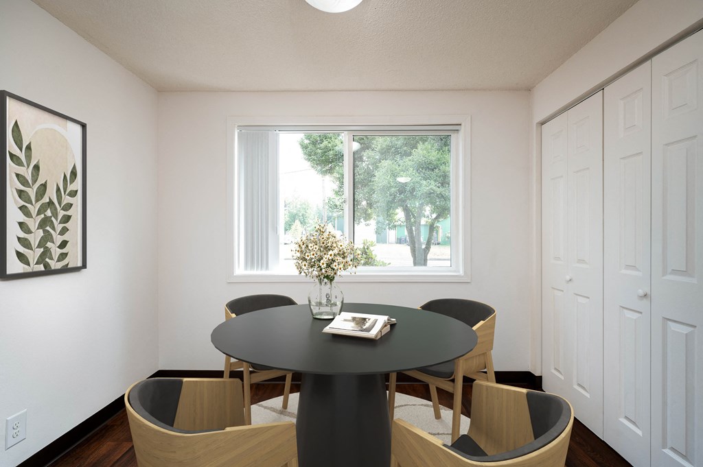 a dining room with a table and chairs and a window