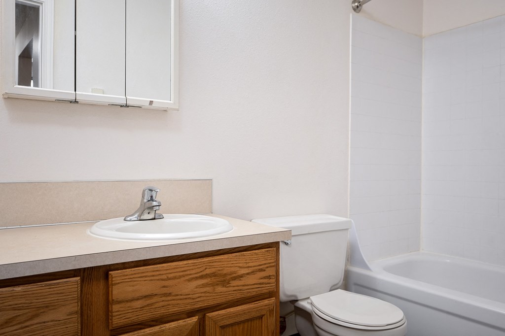 an empty bathroom with a sink toilet and bath tub