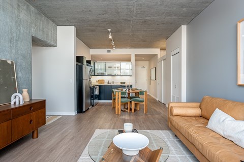 A modern living room with a brown sofa and a wooden coffee table.