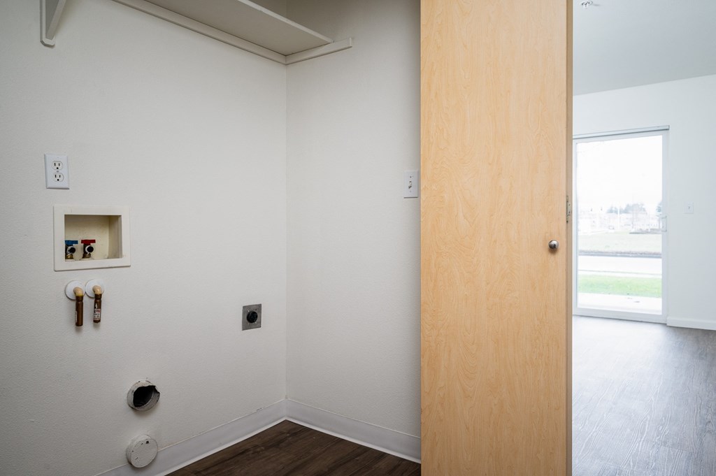 a door in a white room with a window in the background