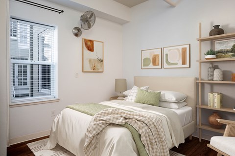 a bedroom with a bed and shelves and a window