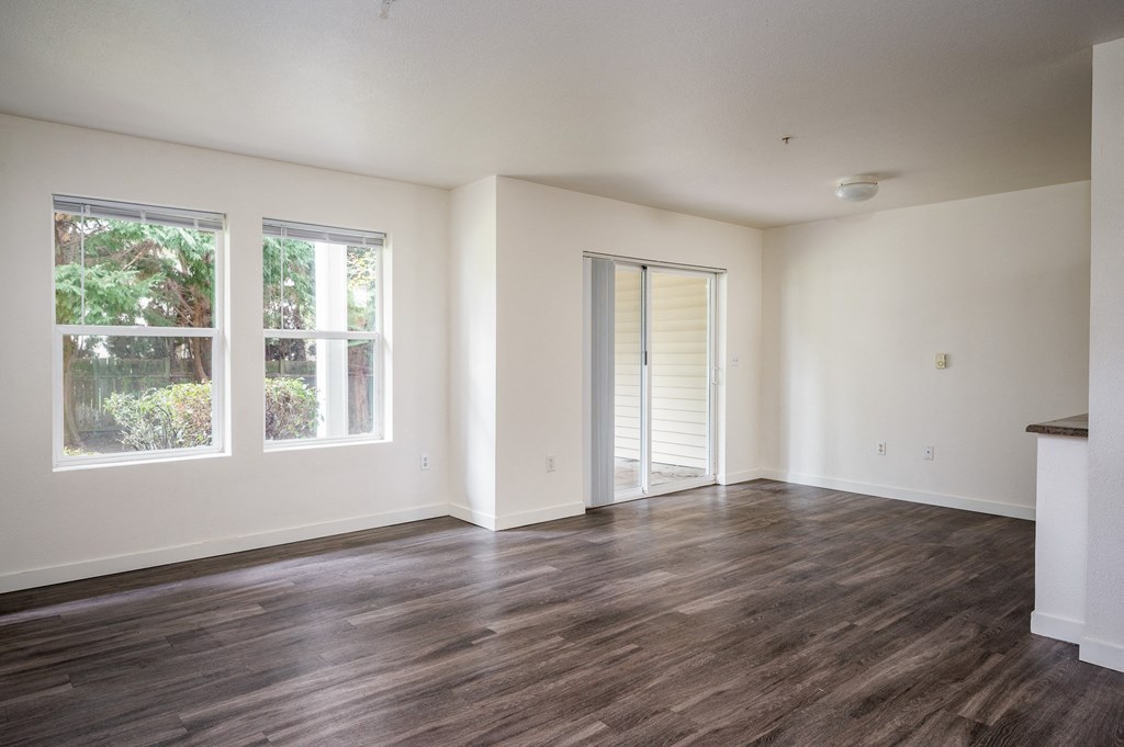a bedroom with hardwood floors and white walls