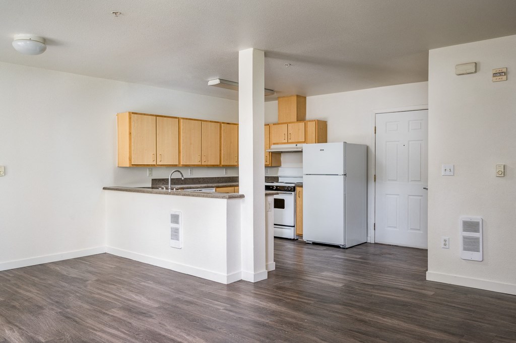 a kitchen with a white refrigerator freezer next to a stove top oven
