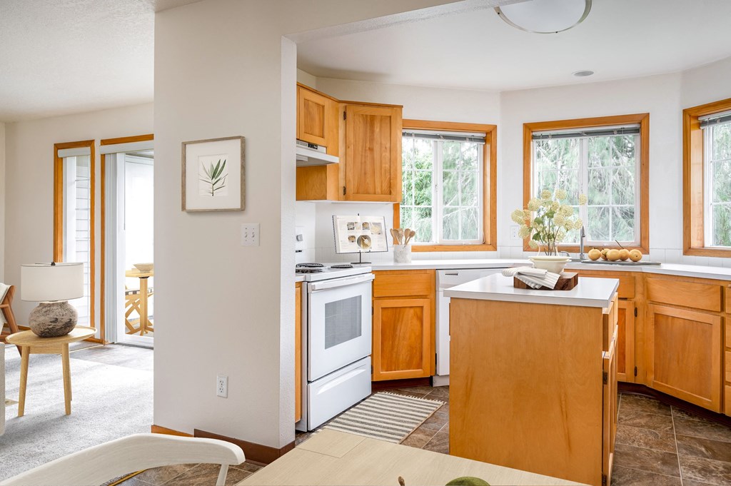 a kitchen with white appliances and wooden cabinets