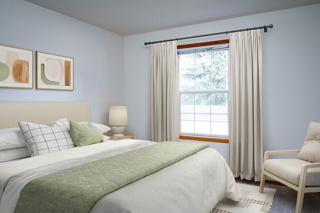 a bedroom with a bed and a chair in a room