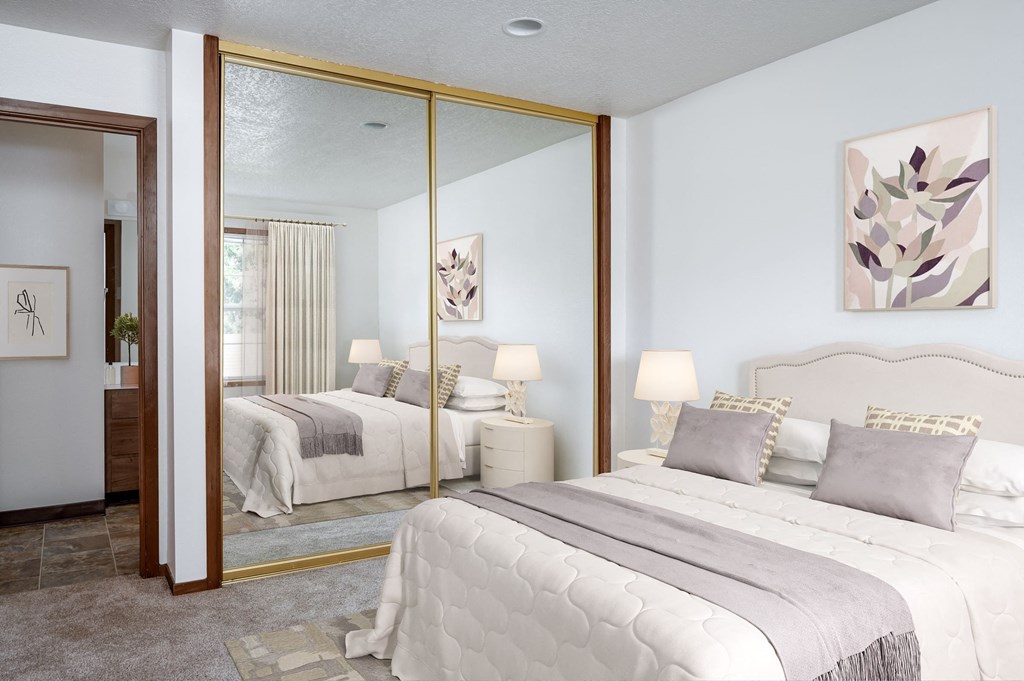 a bedroom with two beds and a large mirror