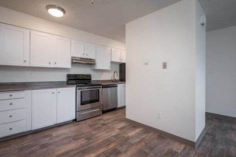 A kitchen with white cabinets and stainless steel appliances.