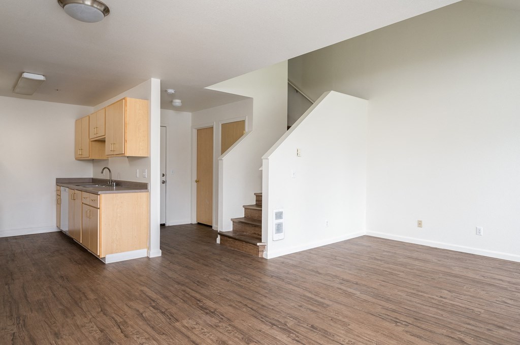 a kitchen and living room in an empty apartment