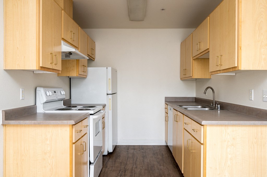 a kitchen with wooden cabinets and white appliances