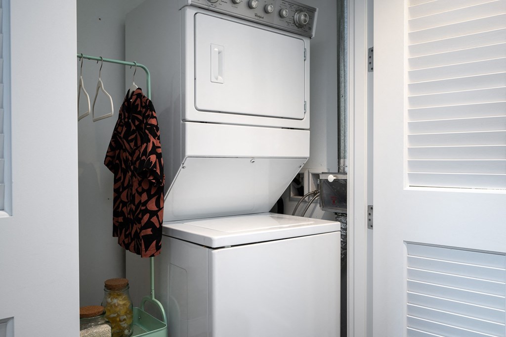 a white washer and dryer in a small laundry room