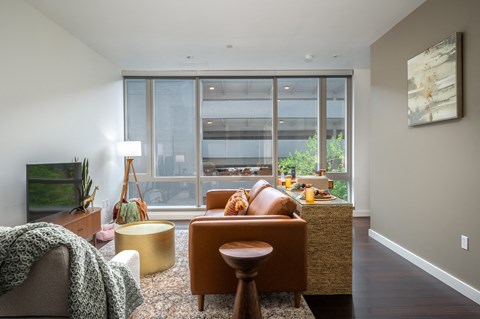 a living room with leather furniture and a large window