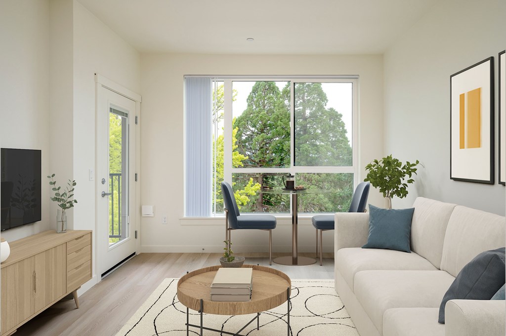 A living room with a white couch, a wooden coffee table, and a flat-screen TV.