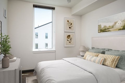 a bedroom with a large bed and a window