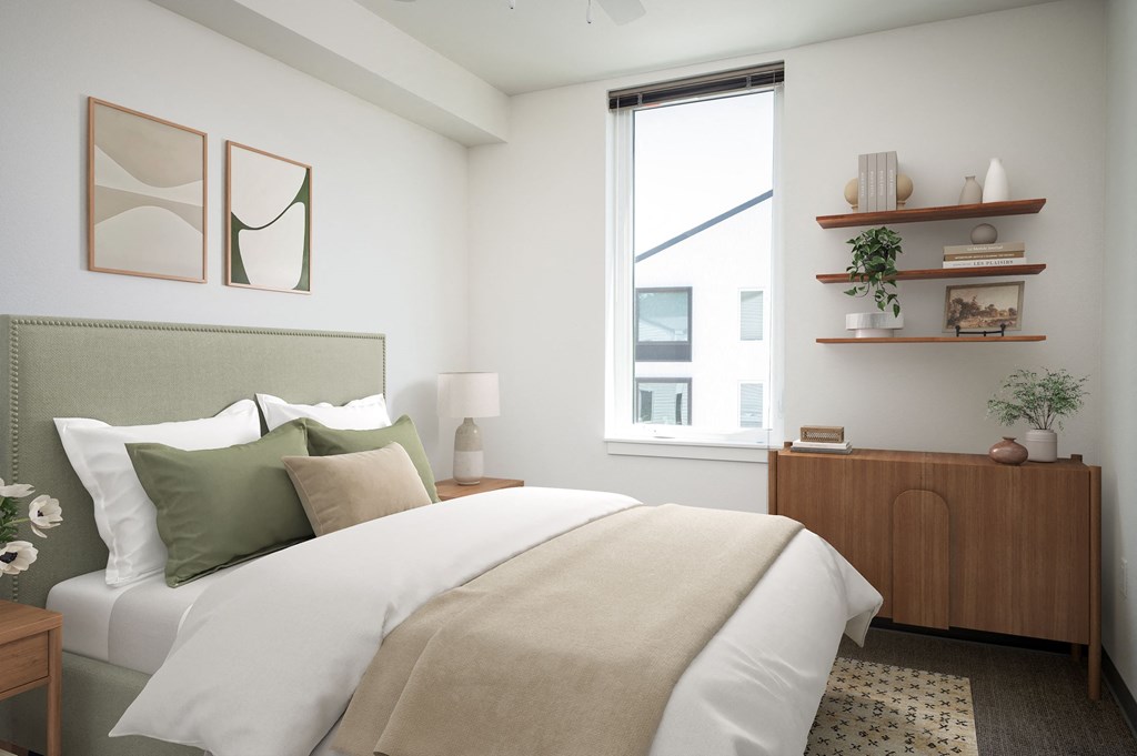 a bedroom with a large bed and a window