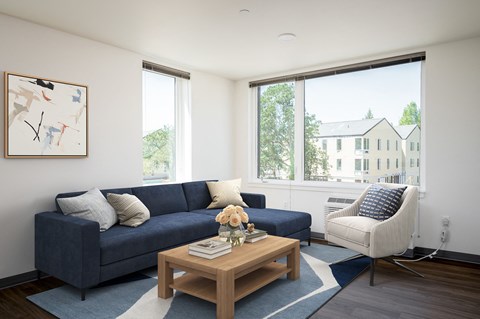 a living room with a blue couch and a coffee table
