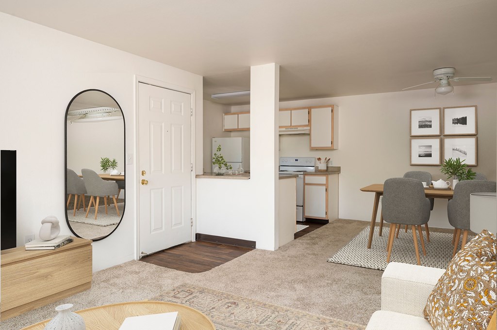 A living room with a round mirror, a white sofa, and a dining table with chairs.