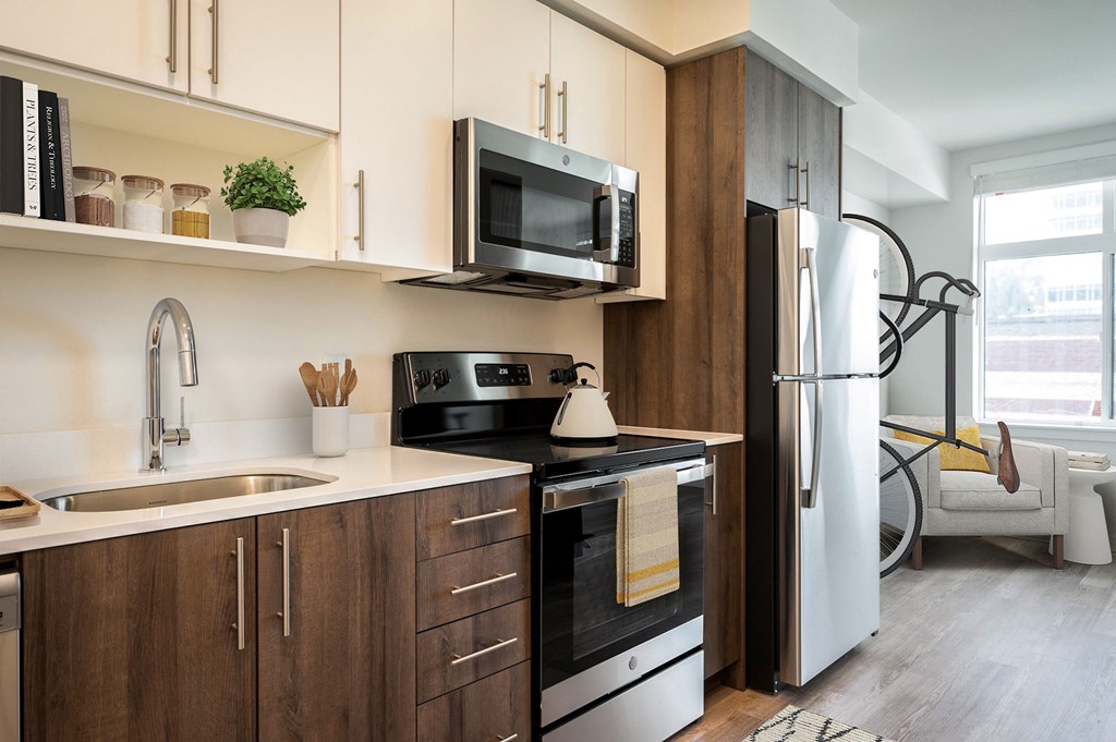 a kitchen with a sink and a refrigerator and a microwave