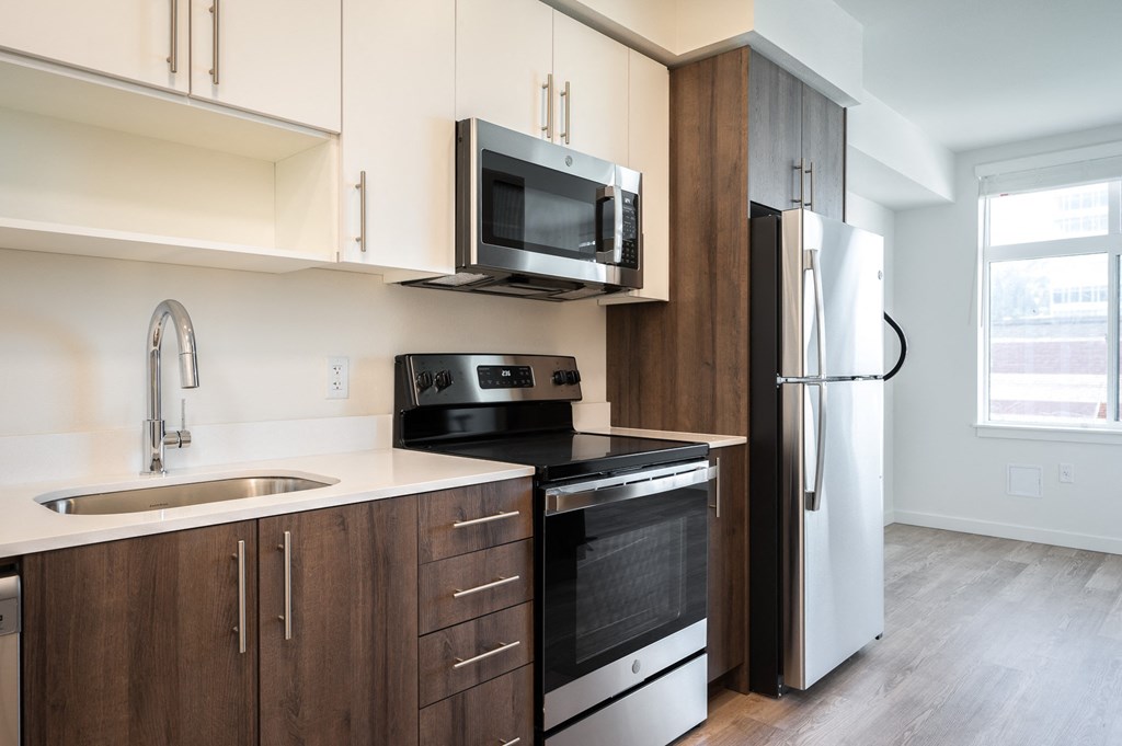 a kitchen with a stove microwave and refrigerator