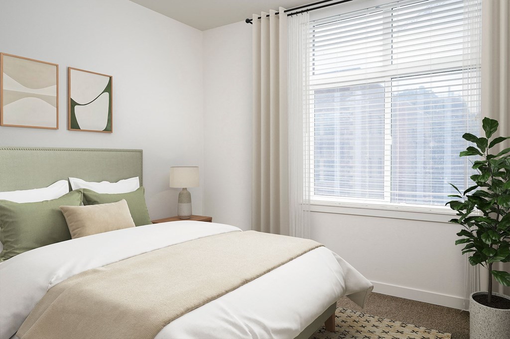 a bedroom with a bed and a large window