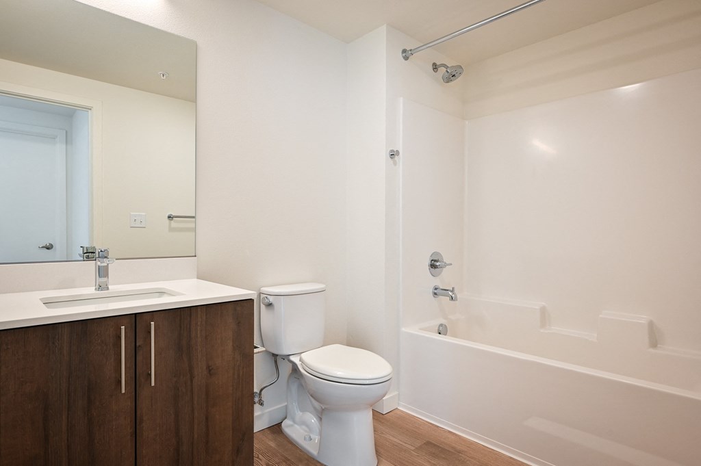 a bathroom with a toilet and a sink and a bath tub
