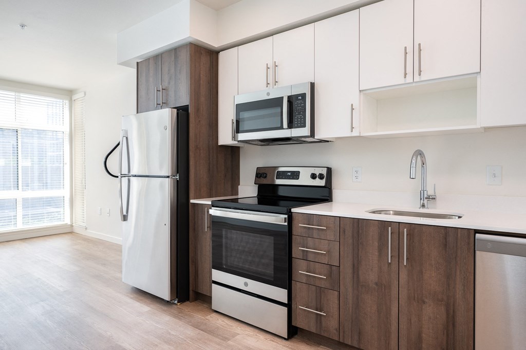 a kitchen with white cabinets and a stove and refrigerator
