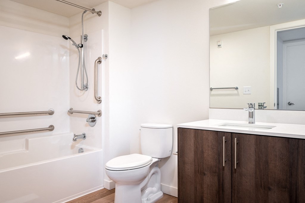 a bathroom with a toilet and a tub and a sink