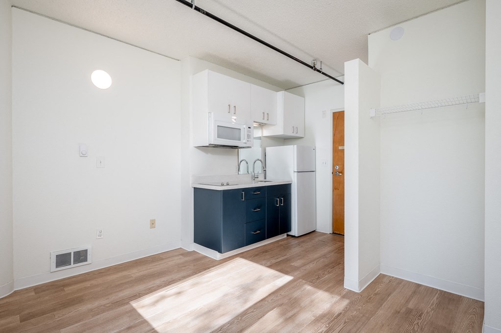 a kitchen with white cabinets and a blue kitchen island