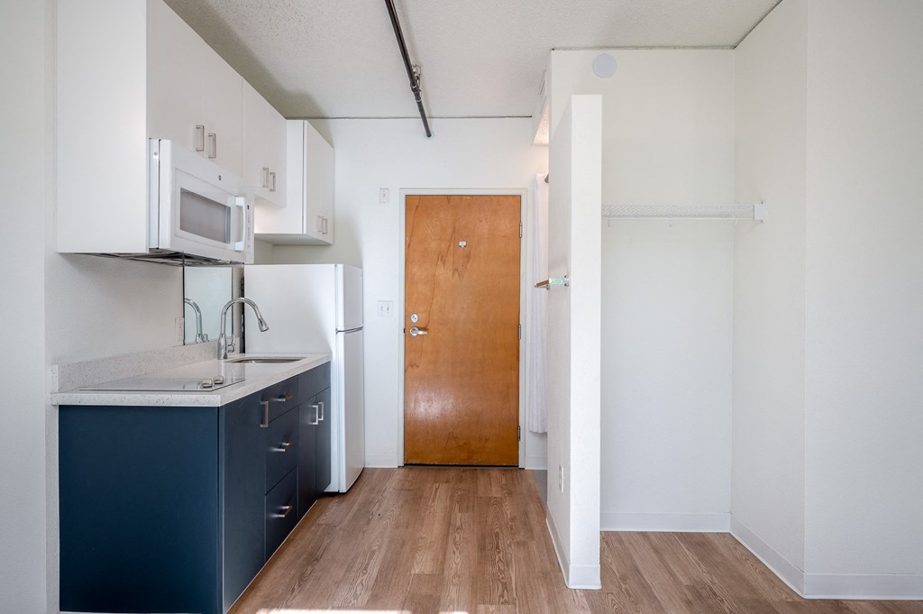 a kitchen with white cabinets and a blue counter top
