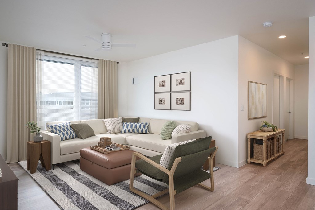 a living room with white walls and wooden floors