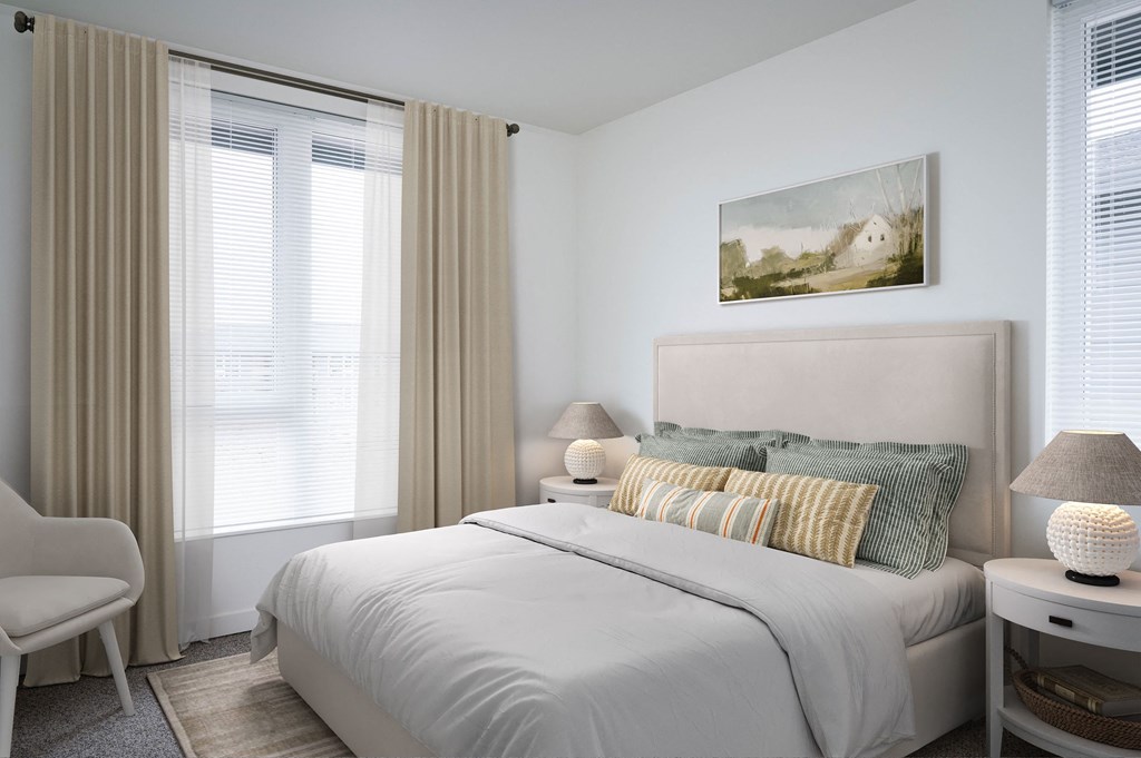 a bedroom with a bed and two windows in a 555 waverly unit