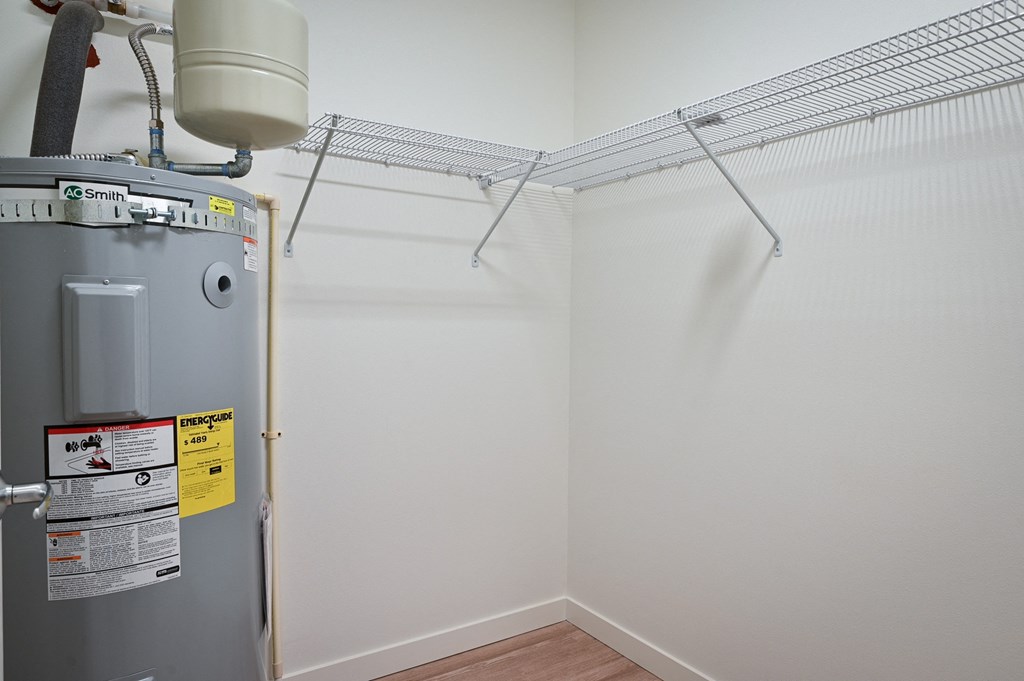 a room with a water heater and a dryer