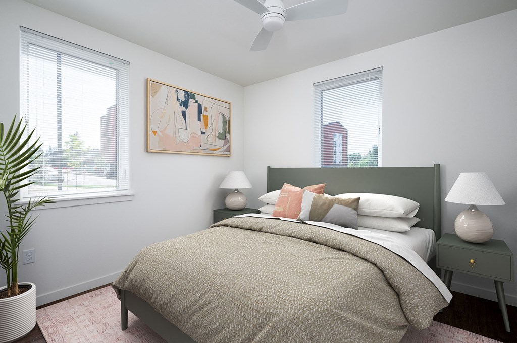 a bedroom with a bed and two windows