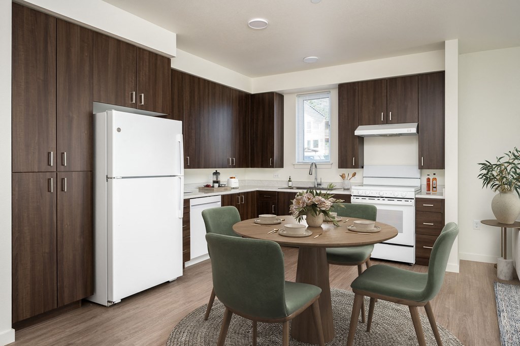 a kitchen and dining room with a table and chairs