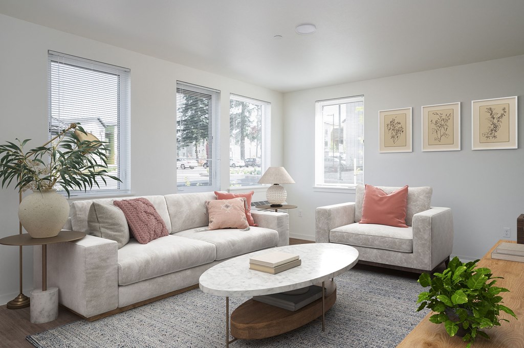 a living room with a couch and two chairs and a coffee table