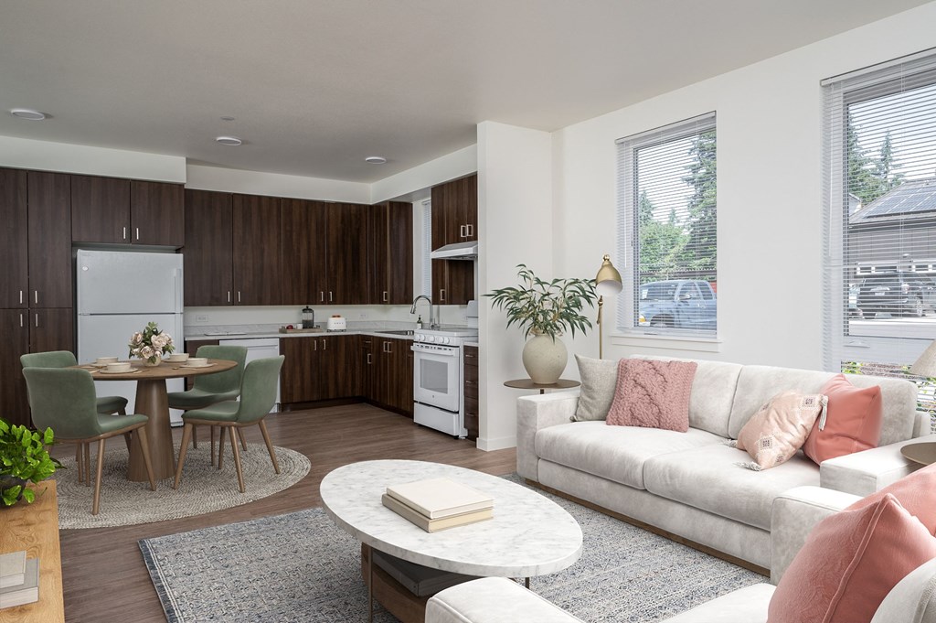 a living room and kitchen with a couch and a table