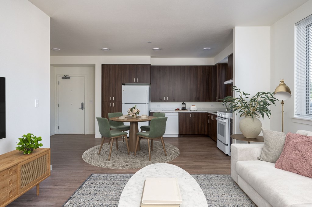 a living room and kitchen with a table and chairs