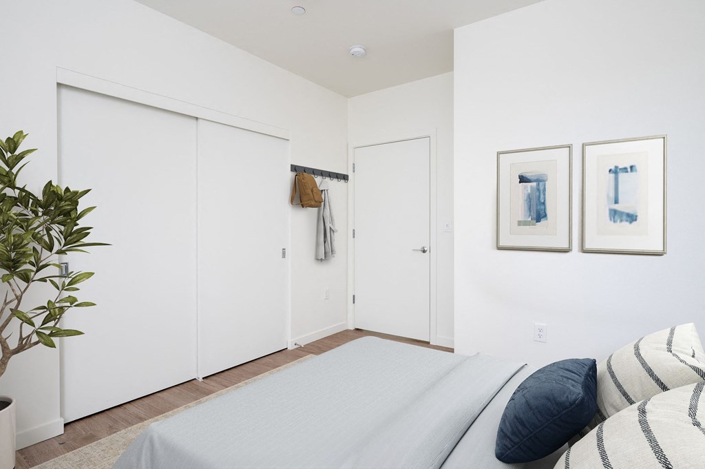 a bedroom with a large bed and two white closets