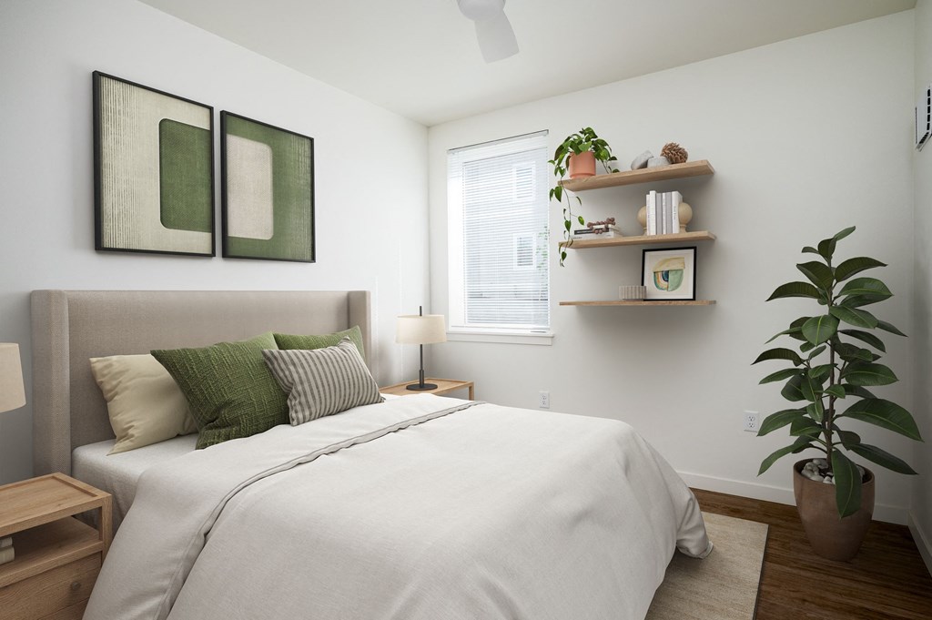 a bedroom with a large bed and a plant